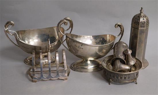 A small group of silver items including pair of sauceboats, toastrack, condiments, sugar sifter etc.